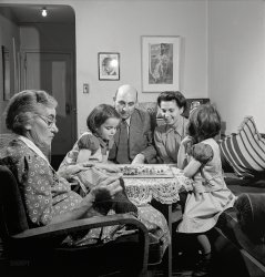 October 1942. "New York, New York. Dr. and Mrs. Winn with daughters Janet and Marie, a Czech-American family, playing Chinese checkers while Grandmother knits." Photo by Marjory Collins, Office of War Information. View full size.