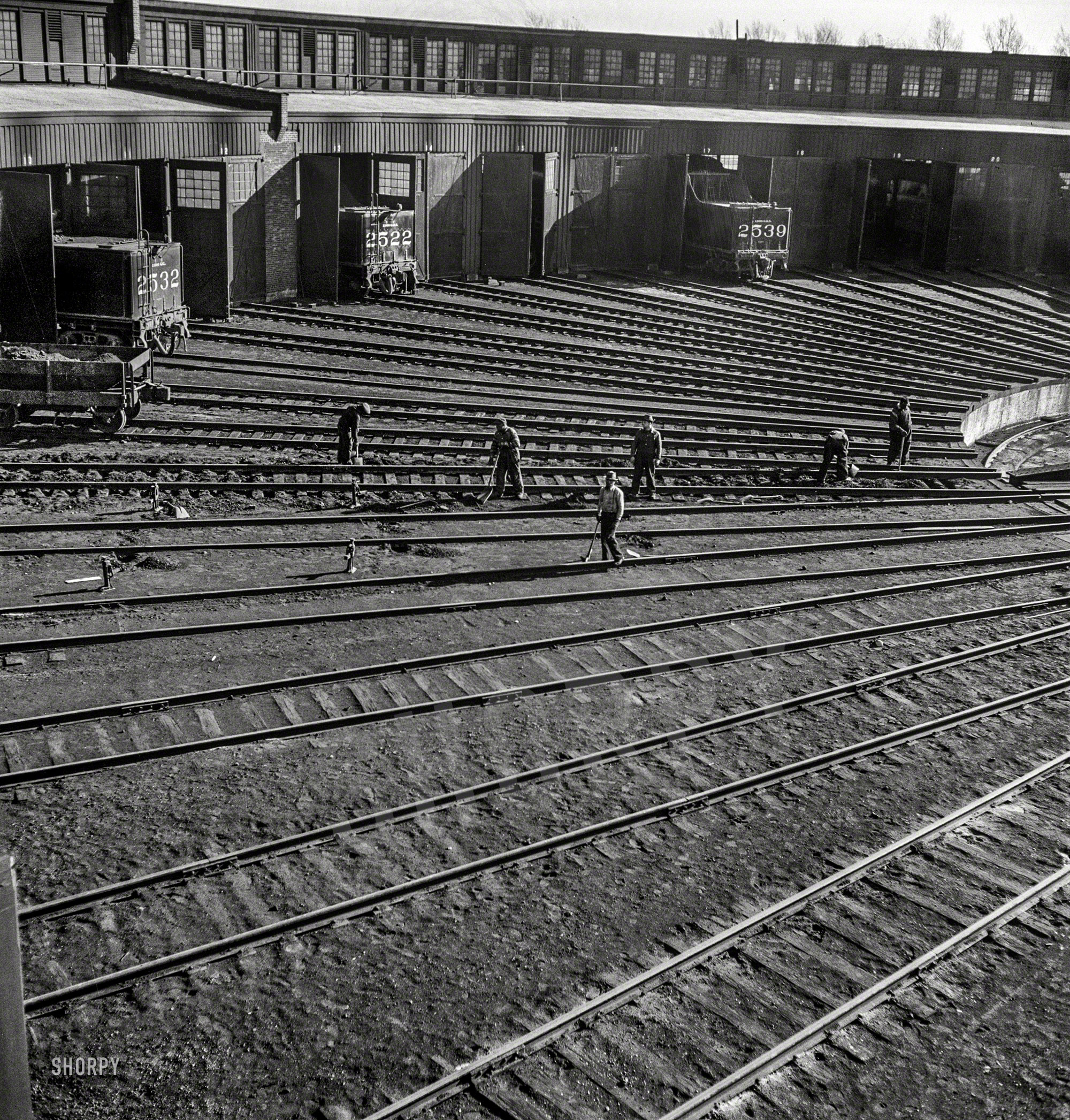 November 1942. "Track crews repairing tracks in the roundhouse at the Illinois Central rail yard, Chicago." Photo by Jack Delano for the OWI. View full size.