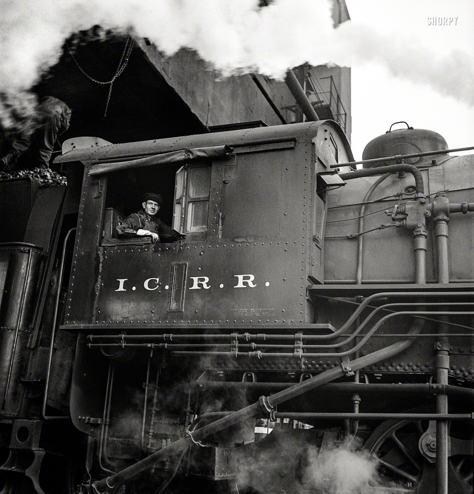 November 1942. "Chicago, Illinois. Engine taking on coal at an Illinois Central Railroad yard." Medium-format negative by Jack Delano. View full size.