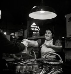 November 1942. Lancaster, Pennsylvania. "Mennonite farm woman at her stall in the Central Market." Medium format nitrate negative by Marjory Collins for the Office of War Information. View full size.
