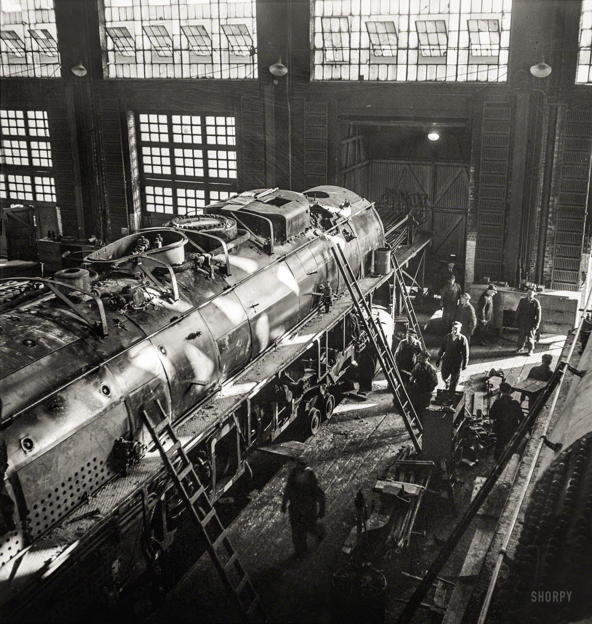 December 1942. Chicago, Illinois. "Working on a giant locomotive, one of the '400s,' in the Chicago & North Western Railroad shops." Medium-format negative by Jack Delano for the Office of War Information. View full size.