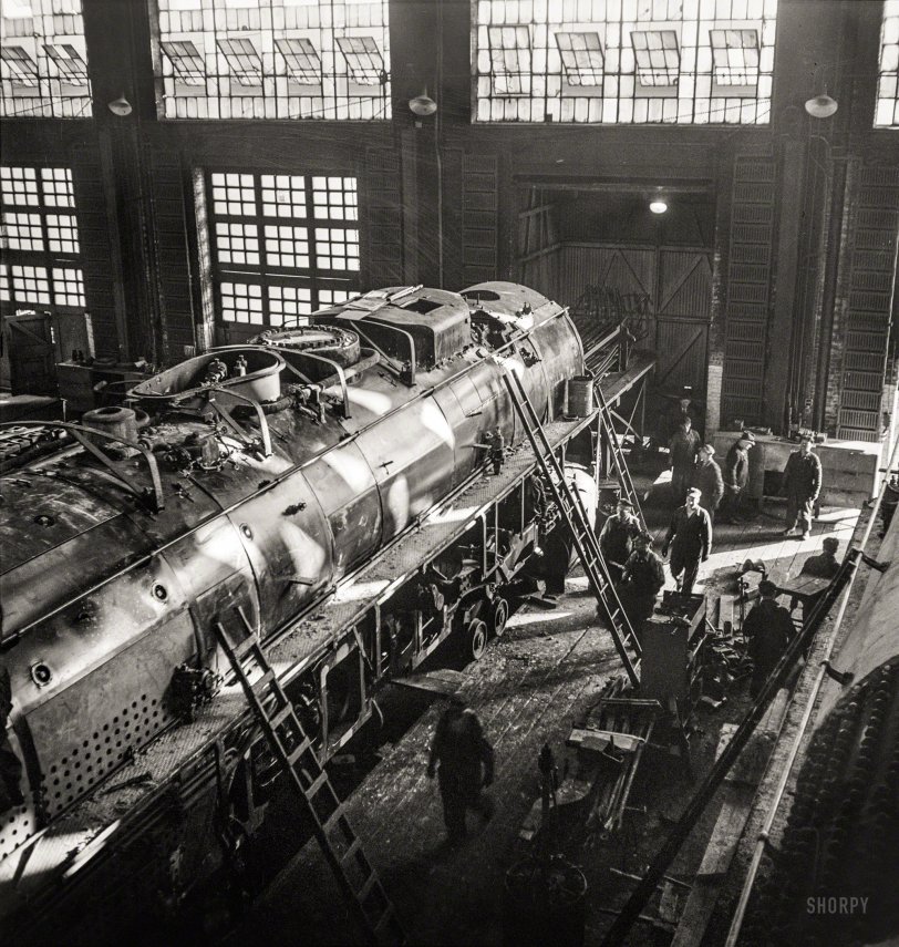 December 1942. Chicago, Illinois. "Working on a giant locomotive, one of the '400s,' in the Chicago &amp; North Western Railroad shops." Medium-format negative by Jack Delano for the Office of War Information. View full size.
