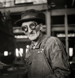 December 1942. "Chicago, Illinois. Workman grinding out a small part at the Chicago & North Western repair shops." Medium-format negative by Jack Delano for the Office of War Information. View full size.