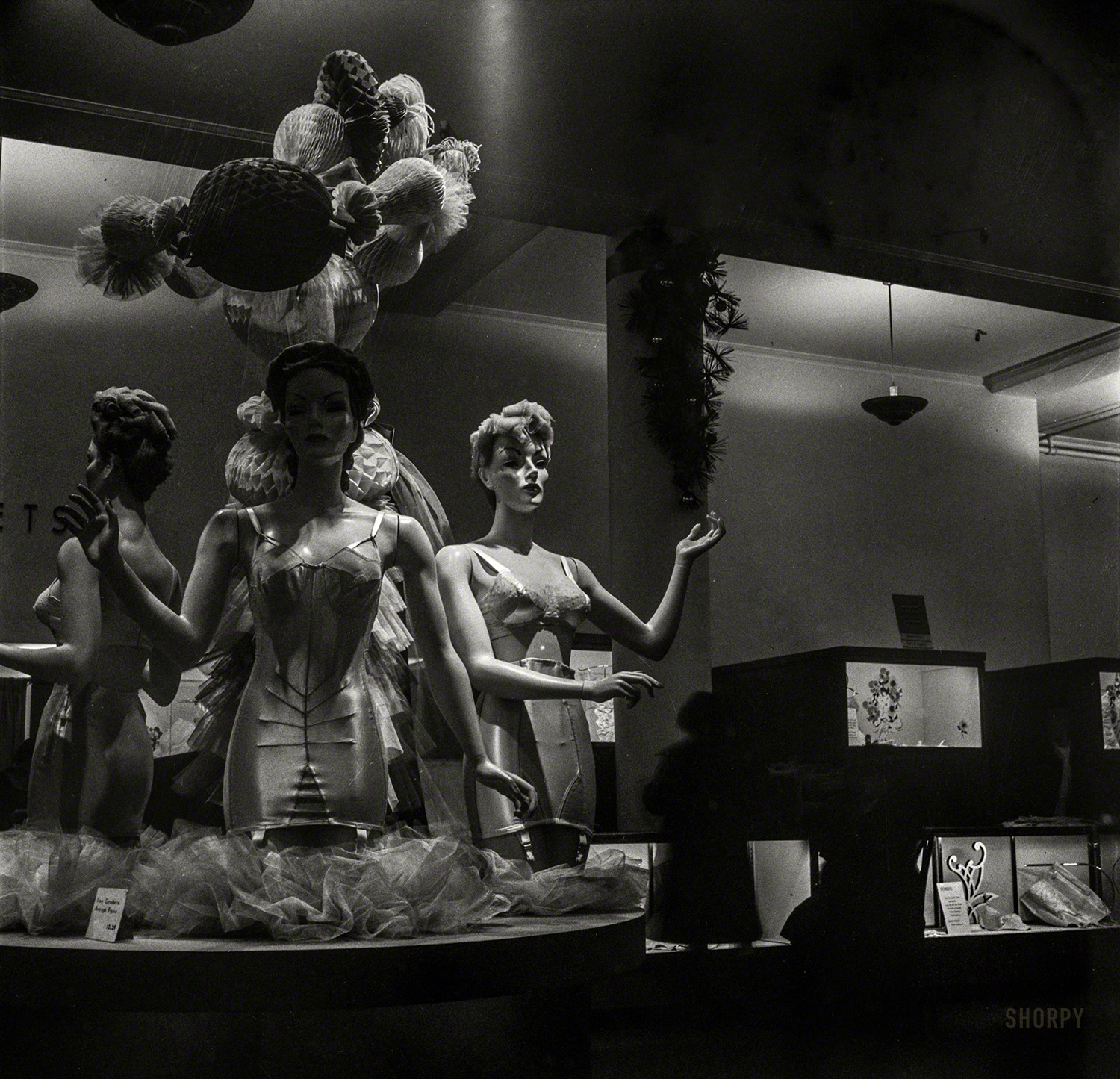 December 1942. "Corset display at R.H. Macy department store the week before Christmas." Photo by Marjory Collins, Office of War Information. View full size.