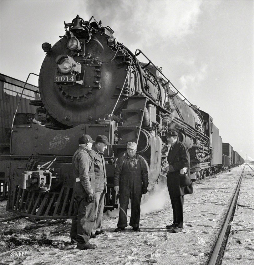 January 1943. "Freight operations on the Chicago & North Western between Chicago and Clinton, Iowa. The crew, with exception of the fireman, chat while waiting for orders to pull out." Photo by Jack Delano. View full size.