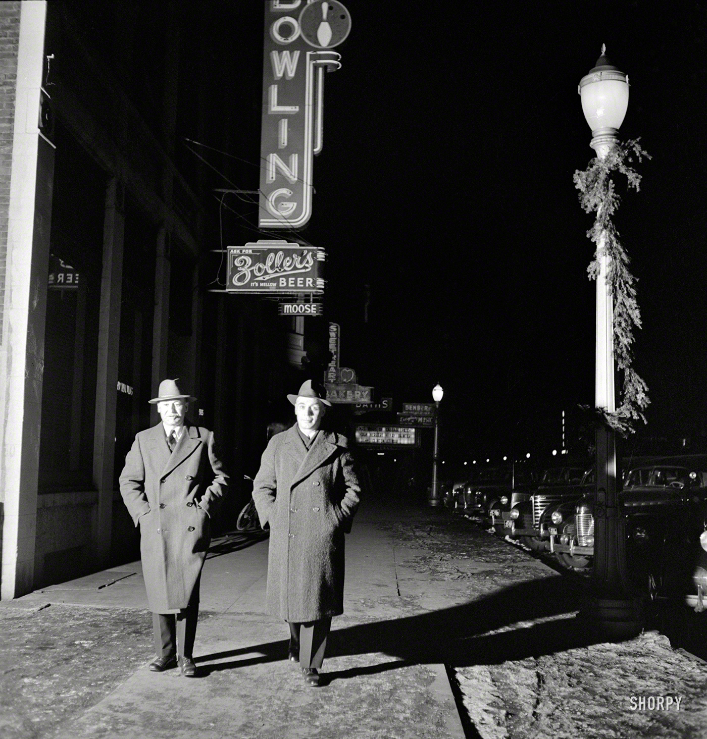 January 1943. Clinton, Iowa. "Residents of Miss Lucille Disher's rooming house for rail workers. Rear brakeman Clarence Averill and James Lynch, engineer on the Pacific Limited who has four sons in the Navy, Marine Corps, Army Air Corps, and Army." Photo by Jack Delano, Office of War Information. View full size.