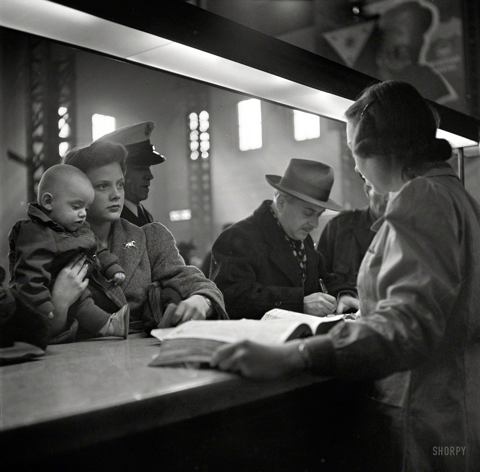 January 1943. "At the information desk at Union Station, Chicago." Our Lady of the Rails. Photo by Jack Delano for the Office of War Information. View full size.