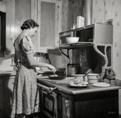 February 1943. Moreno Valley, New Mexico. "William Heck ranch. Mrs. Heck getting supper." Photo by John Collier, Office of War Information. View full size.