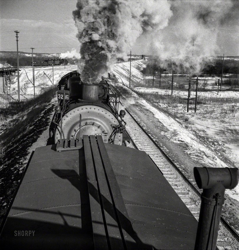 March 1943. "Chillicothe, Illinois. A helper engine is taken on for added power on a grade extending eight miles on the Atchison, Topeka &amp; Santa Fe between Chillicothe, Illinois, and Fort Madison, Iowa." Medium-format negative by Jack Delano for the Office of War Information. View full size.
