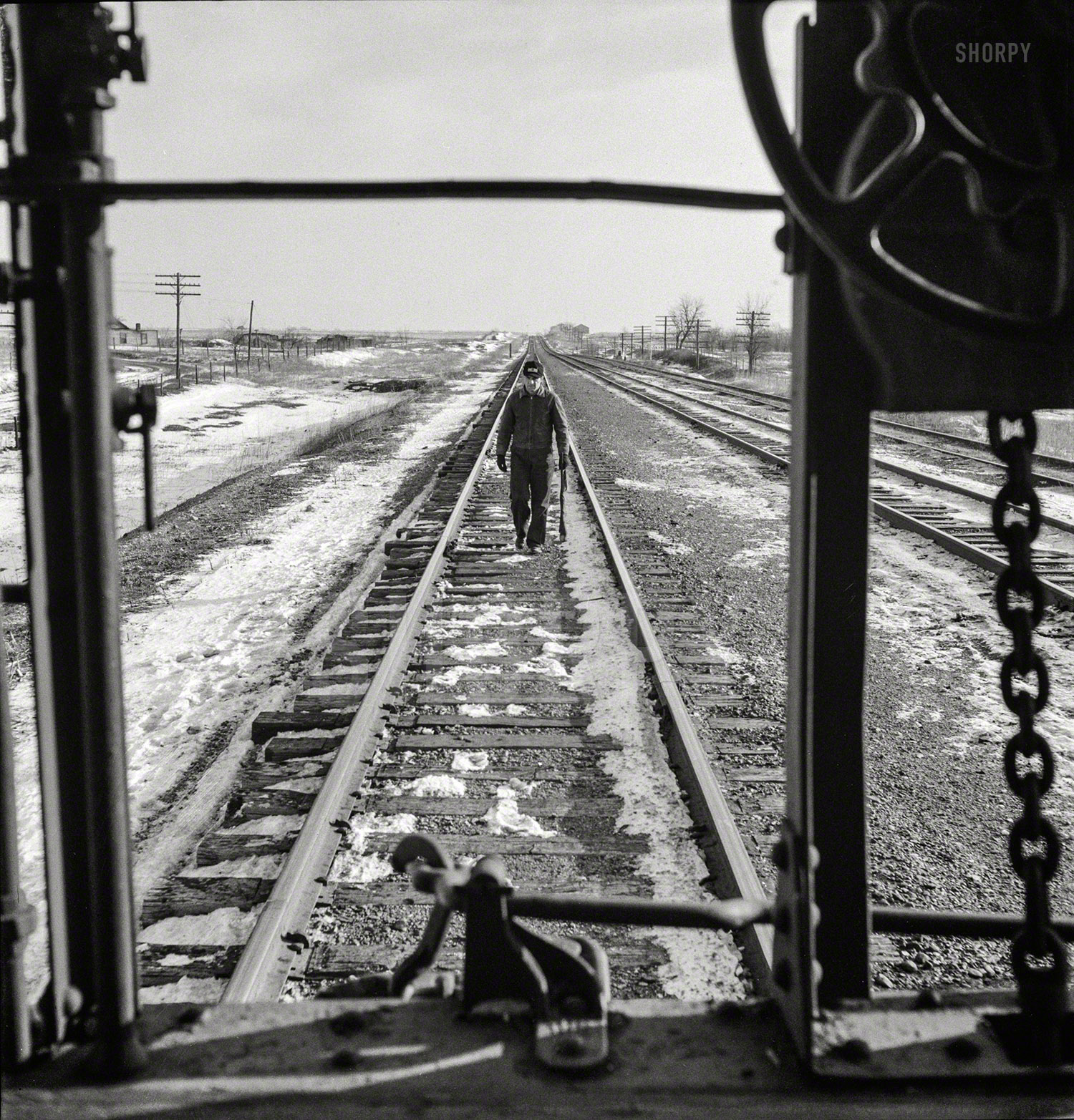 March 1943. "Baring, Missouri. A flagman returning to a train on the Atchison, Topeka & Santa Fe Railroad about to start, after having taken on coal and water." Photo by Jack Delano for the Office of War Information. View full size.