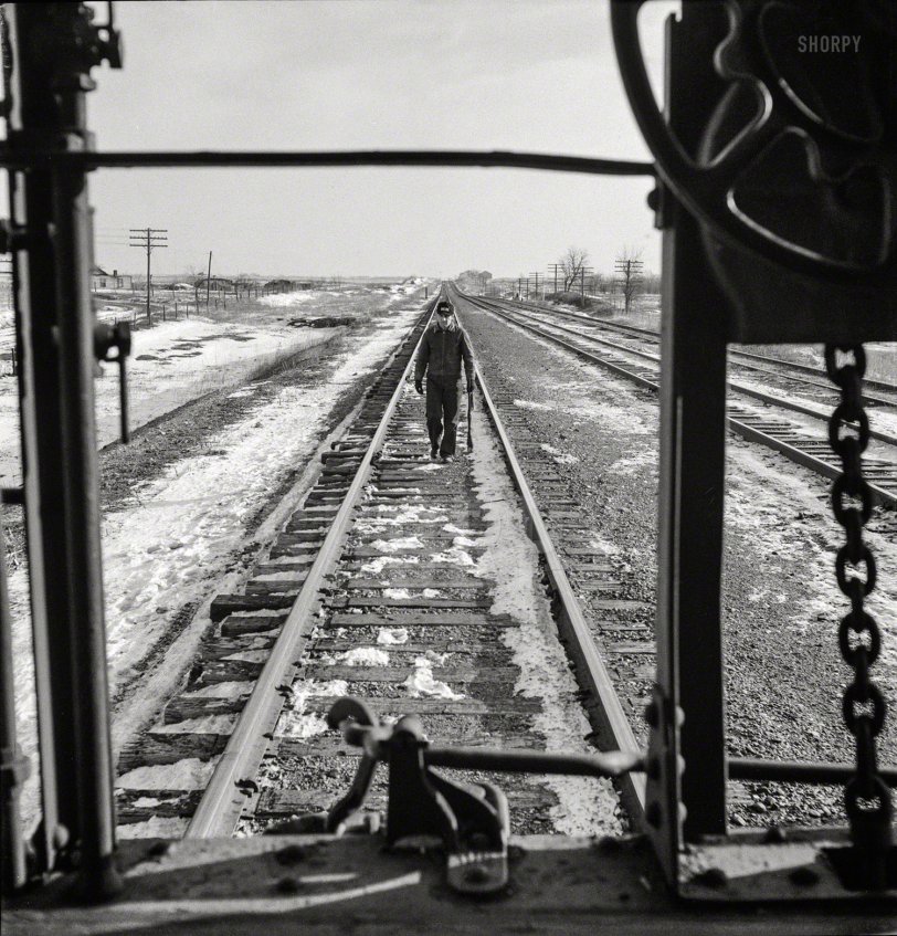 March 1943. "Baring, Missouri. A flagman returning to a train on the Atchison, Topeka &amp; Santa Fe Railroad about to start, after having taken on coal and water." Photo by Jack Delano for the Office of War Information. View full size.
