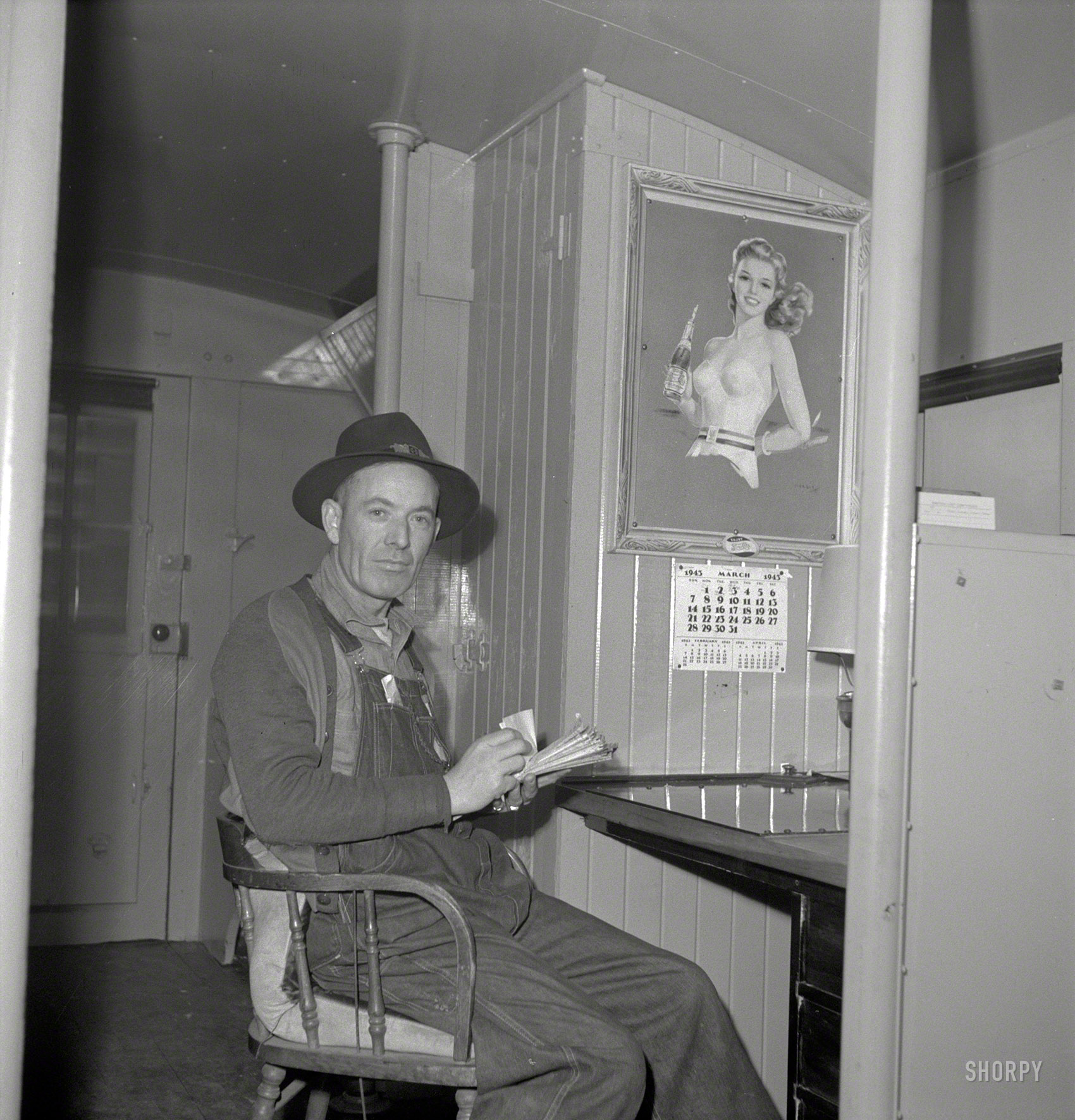 March 1943. "Conductor G. Reynolds, checking his waybills in a caboose of the Atchison, Topeka & Santa Fe Railroad between Argentine and Emporia, Kansas." Photo by Jack Delano for the Office of War Information. View full size.