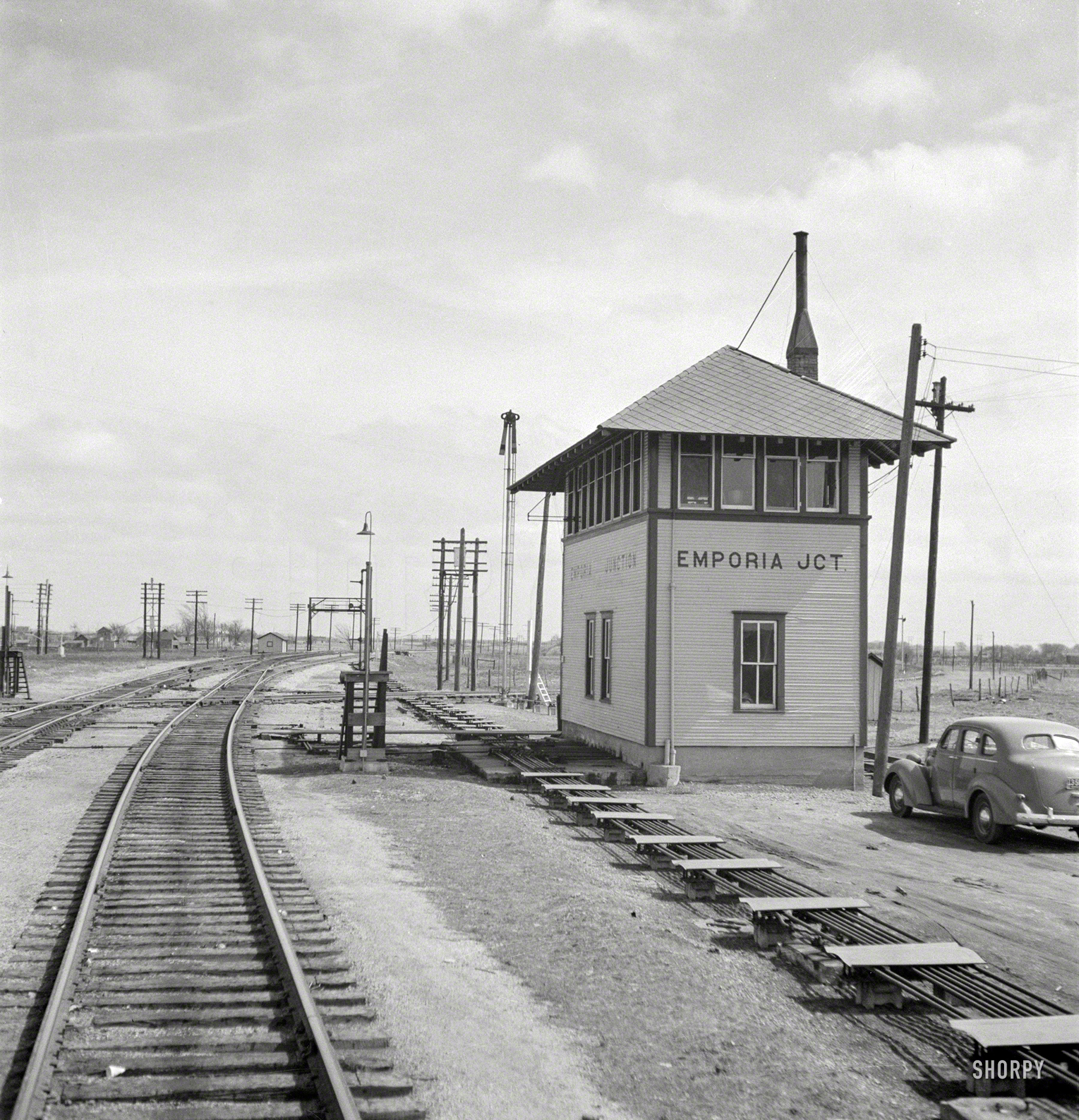 March 1943. "Emporia, Kansas. Passing Emporia Junction switch tower as the Atchison, Topeka & Santa Fe train pulls into the yard." Medium-format negative by Jack Delano for the Office of War Information. View full size.
