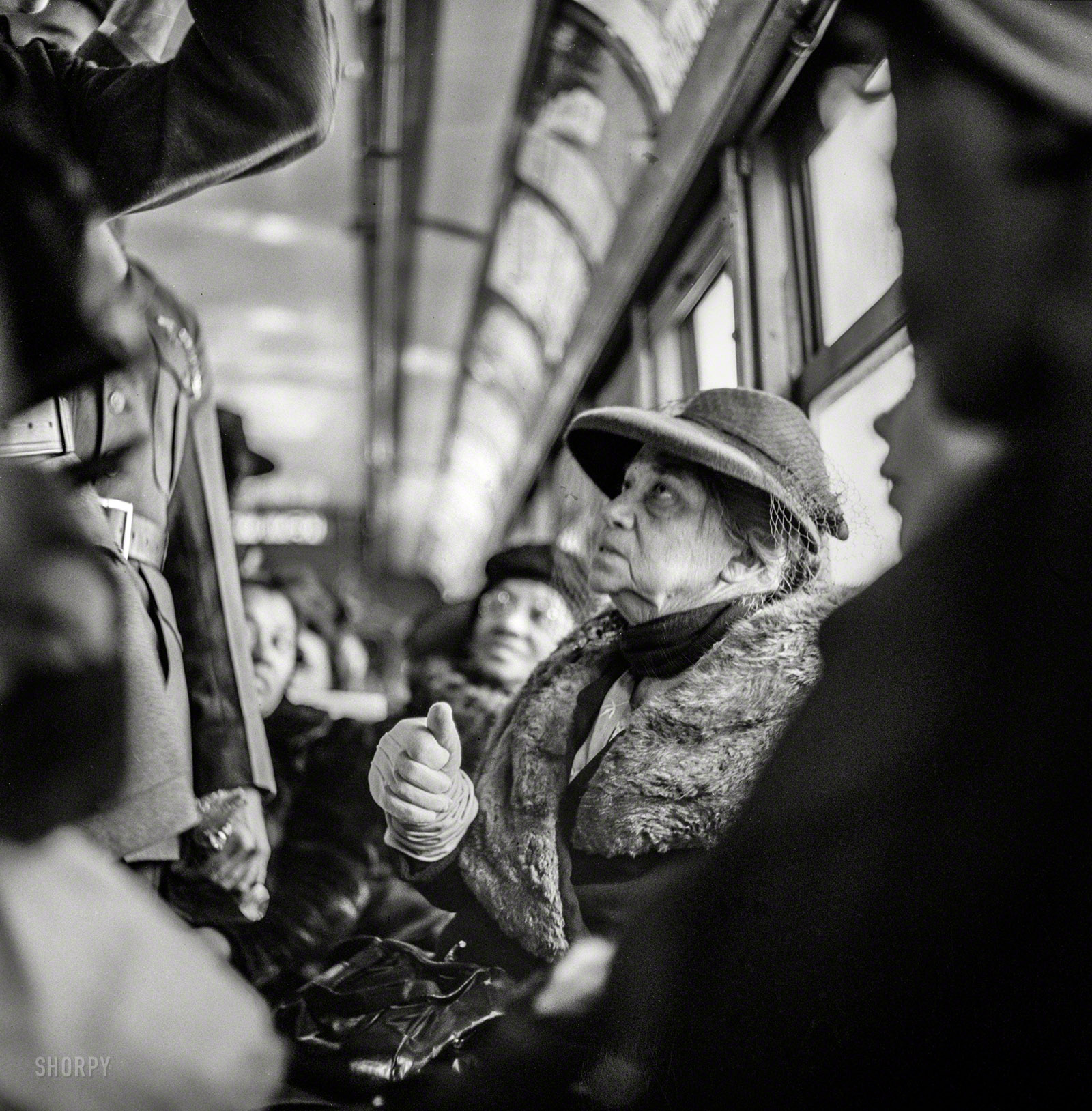 March 1943. "Washington, D.C. -- Riding on a streetcar." More hats with netting! Photo by Esther Bubley for the Office of War Information. View full size.