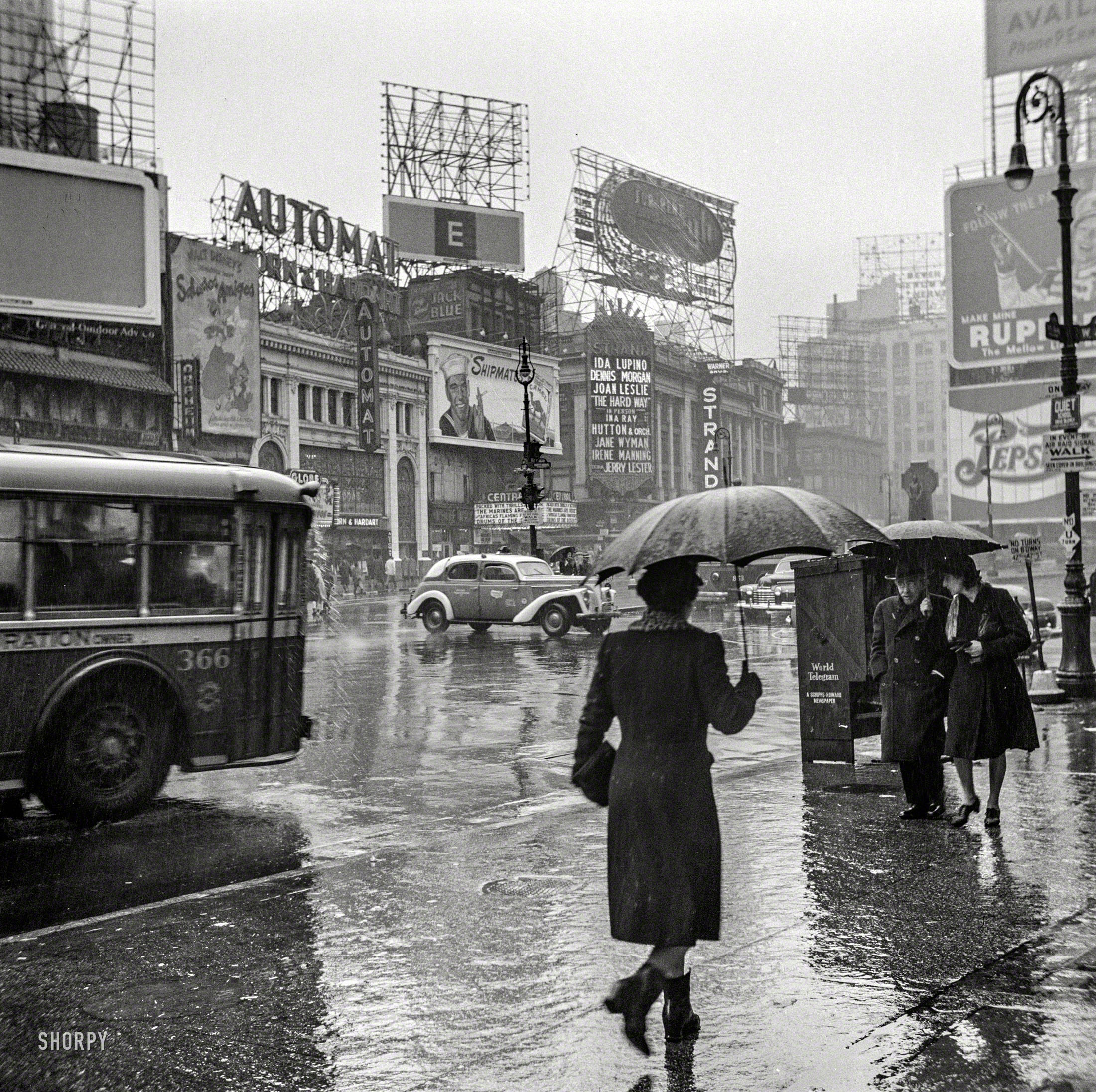 March 1943. "New York, New York. Times Square on a rainy day." Photo by John Vachon for the Office of War Information. View full size.