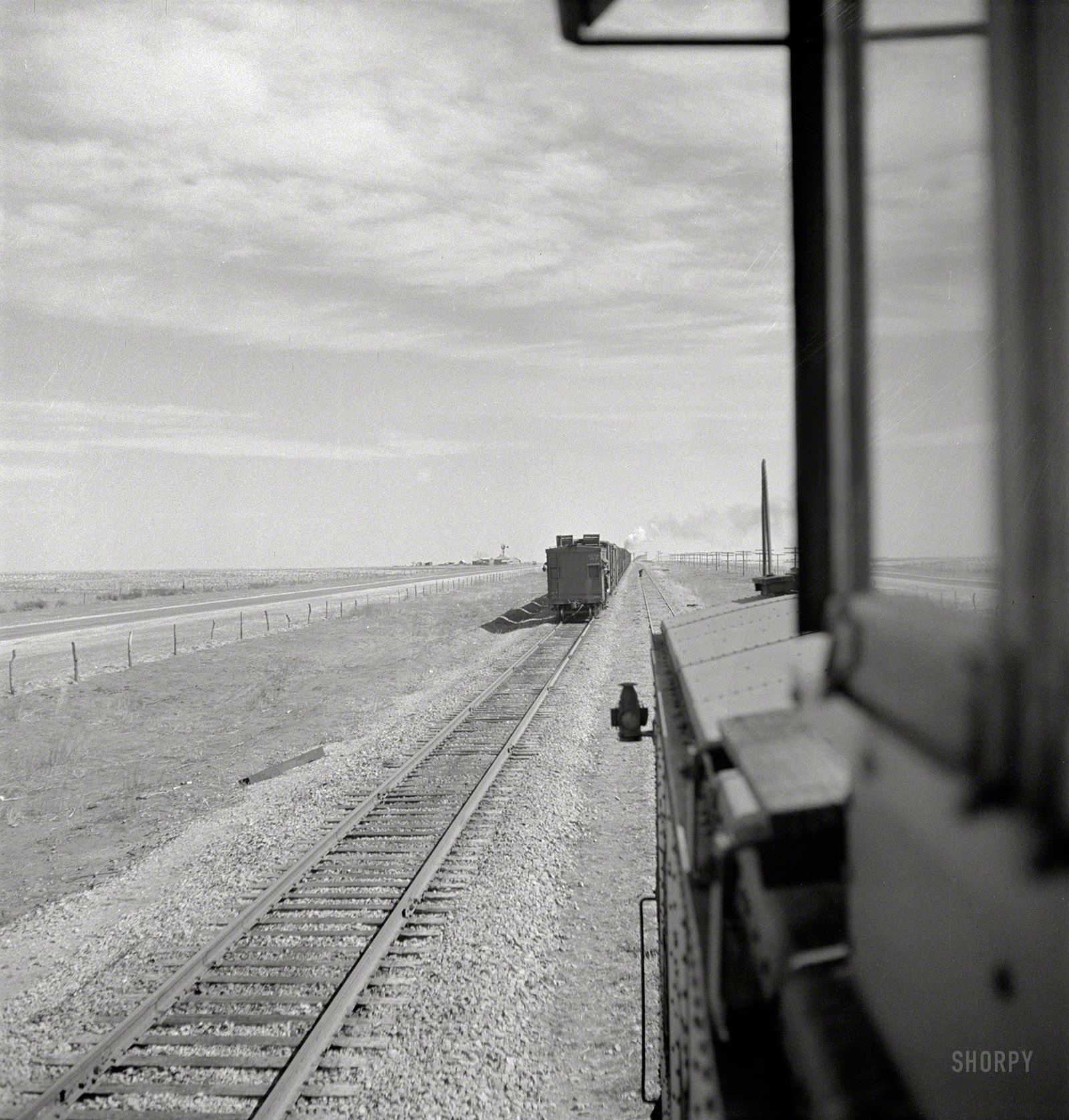 March 1943. "Parmerton, Texas. Passing an eastbound freight on the Santa Fe Railroad between Amarillo and Clovis, New Mexico." Medium-format negative by Jack Delano for the Office of War Information. View full size.