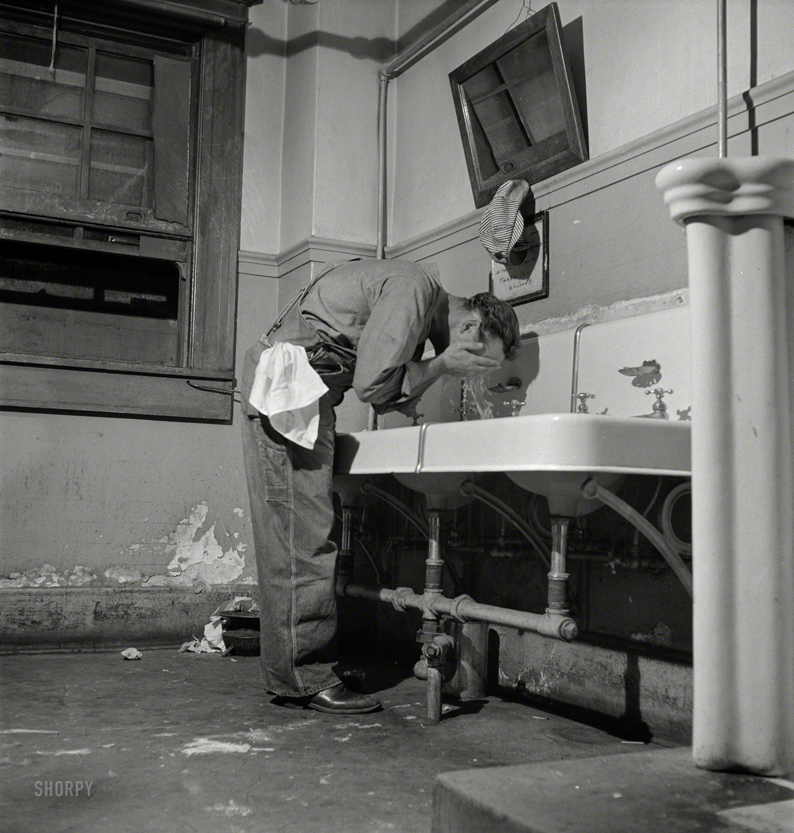 March 1943. Barstow, California. "Railroad worker in the washroom of the reading room in the Santa Fe yard." Medium-format negative by Jack Delano for the Office of War Information. View full size.