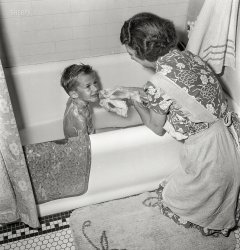 September 1942. Rochester, New York. "Earl Babcock's mother helping with his bath." Photo by Ralph Amdursky, Office of War Information. View full size.