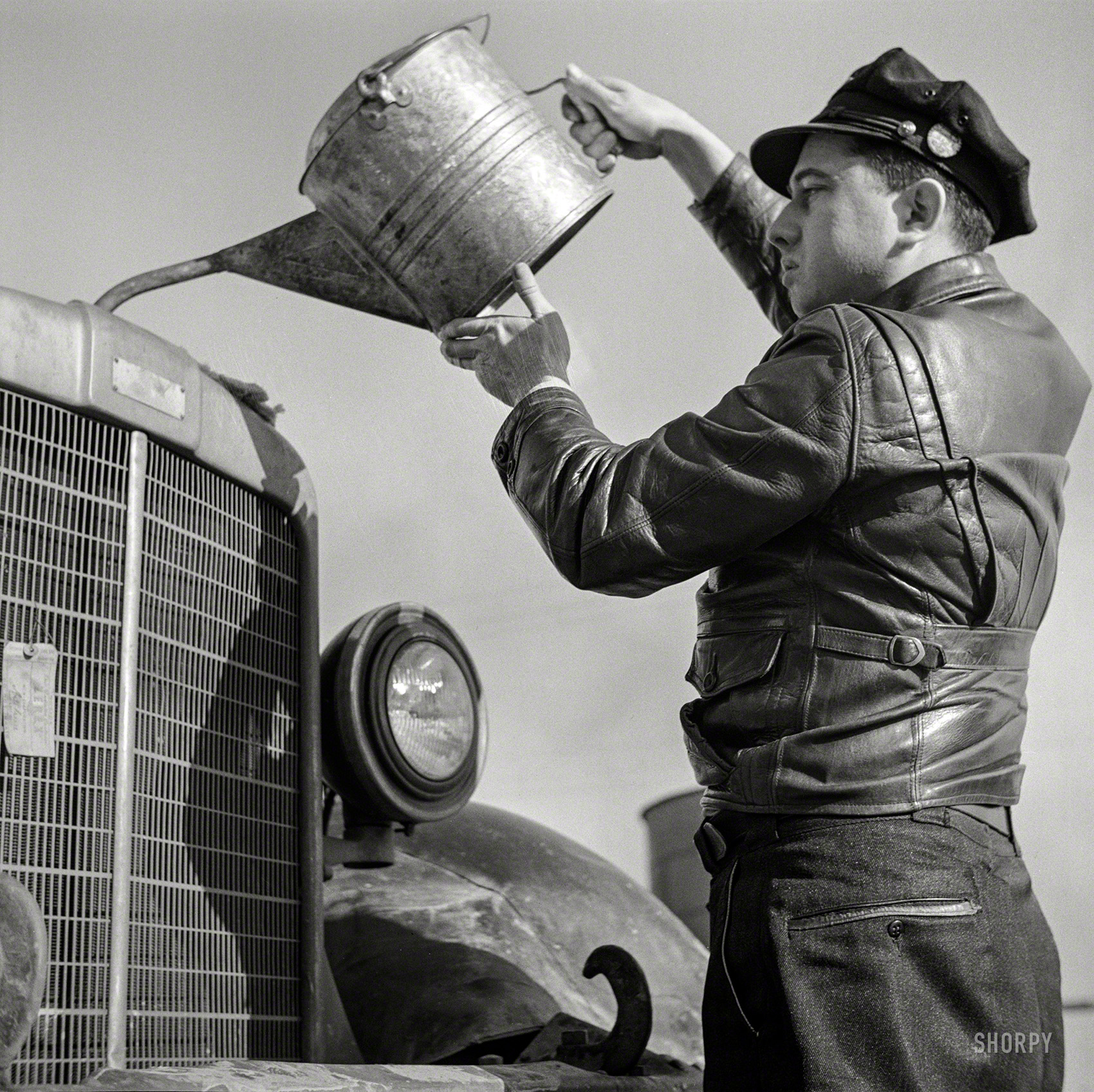 March 1943. "Melvin Cash, truck driver, putting water in his radiator along U.S. Highway 29 in North Carolina en route to Charlotte." Medium format negative by John Vachon for the Office of War Information. View full size.