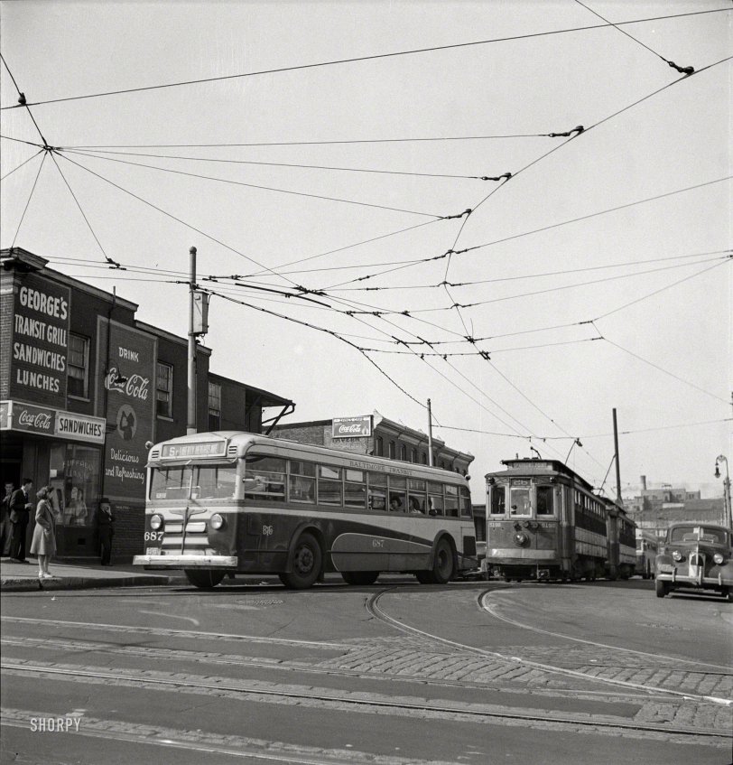 April 1943. Baltimore, Maryland. "Baltimore Transit bus with trolleys of 1917 vintage. Many old cars have been reconditioned because of wartime transportation pressure." Photo by Marjory Collins, Office of War Information. View full size.
