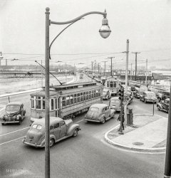 April 1943. "Traffic jam on the road from the Bethlehem Fairfield shipyard to Baltimore as the second shift of workers leaves the plant." Medium-format negative by Marjory Collins for the Office of War Information. View full size.