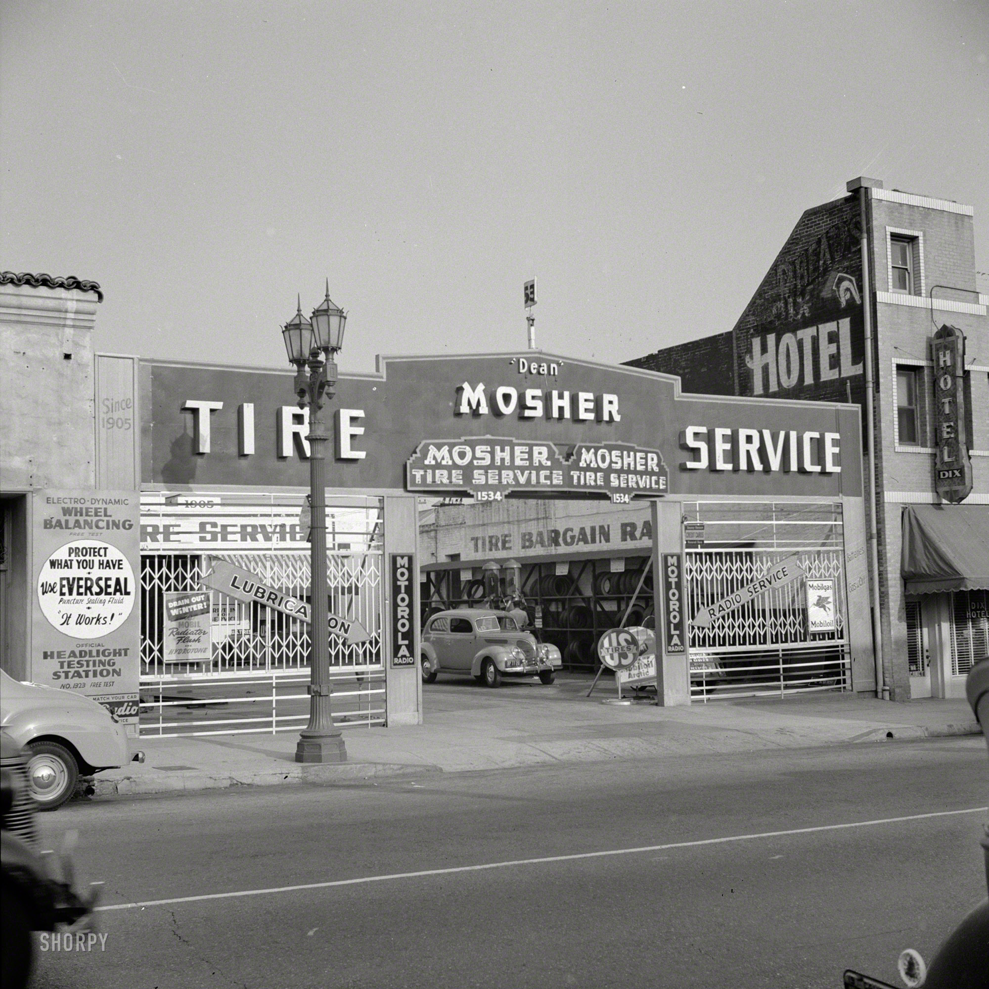 1942. "Hollywood, California. Tire service station." Mosher Tire, next door to the Dix Hotel. Photo by Russell Lee for the Office of War Information. View full size.
