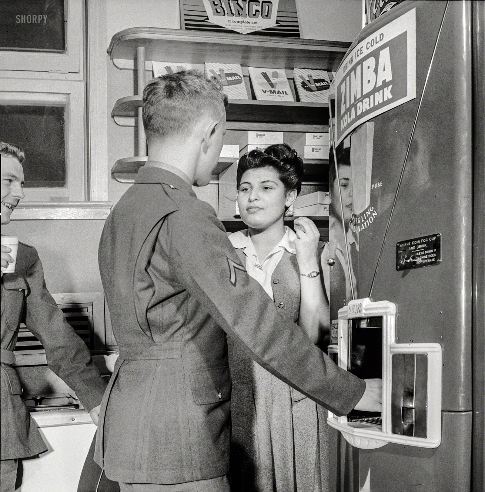 June 1943. Arlington, Virginia. "A soldier treating his date to a coke in the service shop at Idaho Hall, Arlington Farms, a residence for women who work in the U.S. government for the duration of the war." The Zimba Kola people (as well as the Coca-Cola Co., whose logo is barely visible above the machine) would probably be pained to see their products referred to as lowercase-generic "coke." Photo by Esther Bubley for the Office of War Information. View full size.