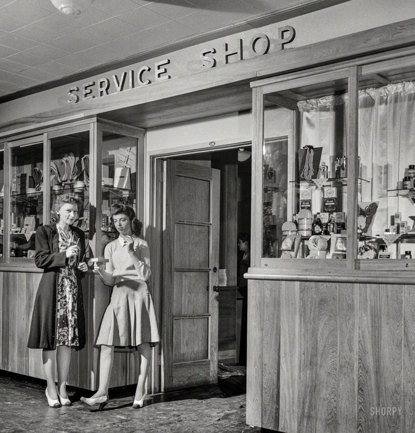 June 1943. Arlington, Virginia. "Service shop in Idaho Hall, Arlington Farms, a residence for women who work in the U.S. government for the duration of the war. These shops, one in each residence hall, sell cosmetics, drugs, sandwiches, Cokes, etc." Photo by Esther Bubley for the Office of War Information. View full size.
