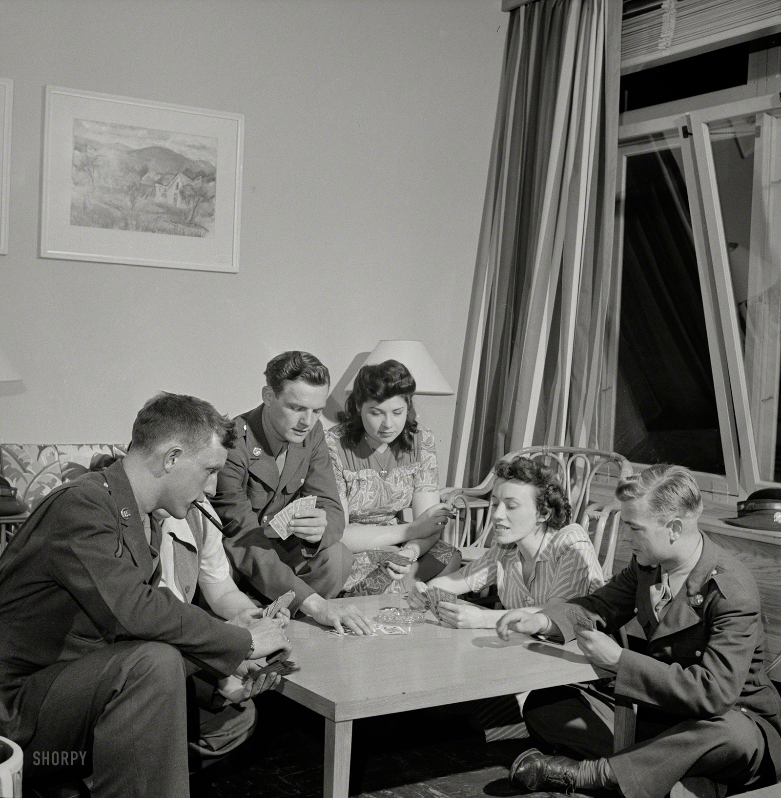 June 1943. Arlington, Virginia. "Girls entertaining their guests in one of the two card rooms at a residence for the women who work in the U.S. government for the duration of the war. More privacy is afforded here than in the main lounge." Photo by Esther Bubley for the Office of War Information. View full size.
