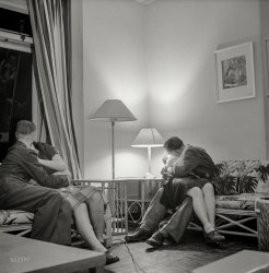 June 1943. Arlington, Virginia. "Girls entertaining their guests in one of the two card rooms at a residence for the women who work in the U.S. government for the duration of the war. More privacy is afforded here than in the main lounge." Ignoring the fact that the Card Room has Esther Bubley taking your picture for the Office of War Information. The sequel to our previous post after what seems to have been some rearranging of lamps and card players. View full size.