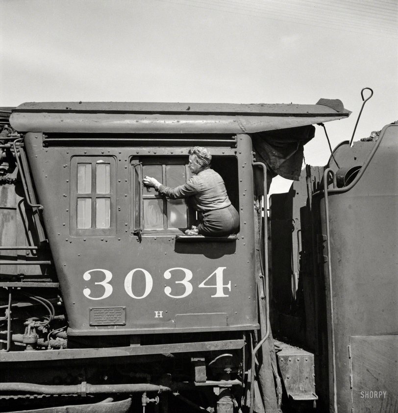 May 1943. "Clinton, Iowa. Women wipers of the Chicago &amp; North Western cleaning one of the giant freight locomotives." Medium-format negative by Jack Delano for the Office of War Information. View full size.
