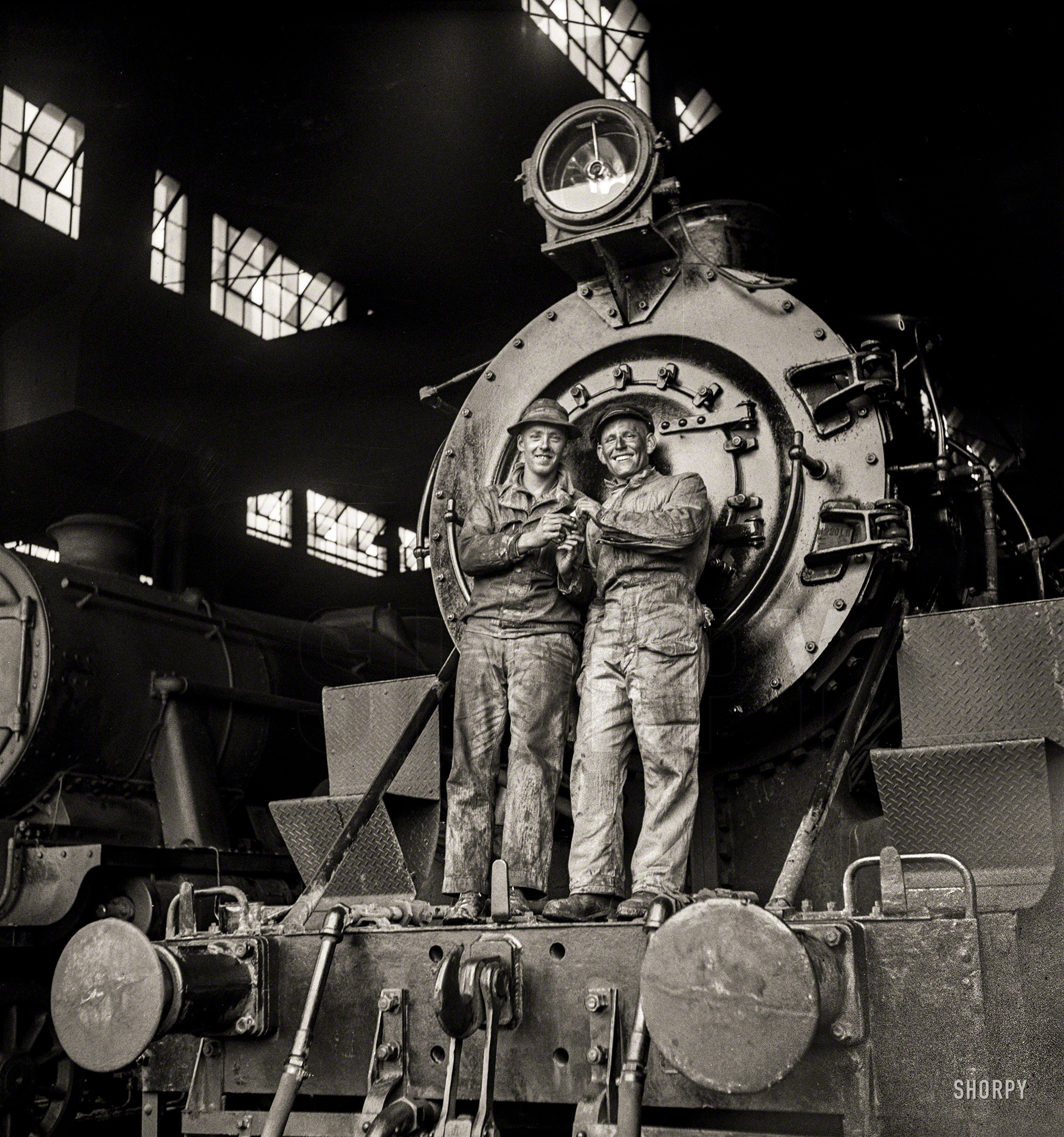 March 1943. "American and British engineers taking time out for a smoke. They are standing on an American locomotive somewhere in Iran." Medium-format negative by Nick Parrino for the Office of War Information. View full size.