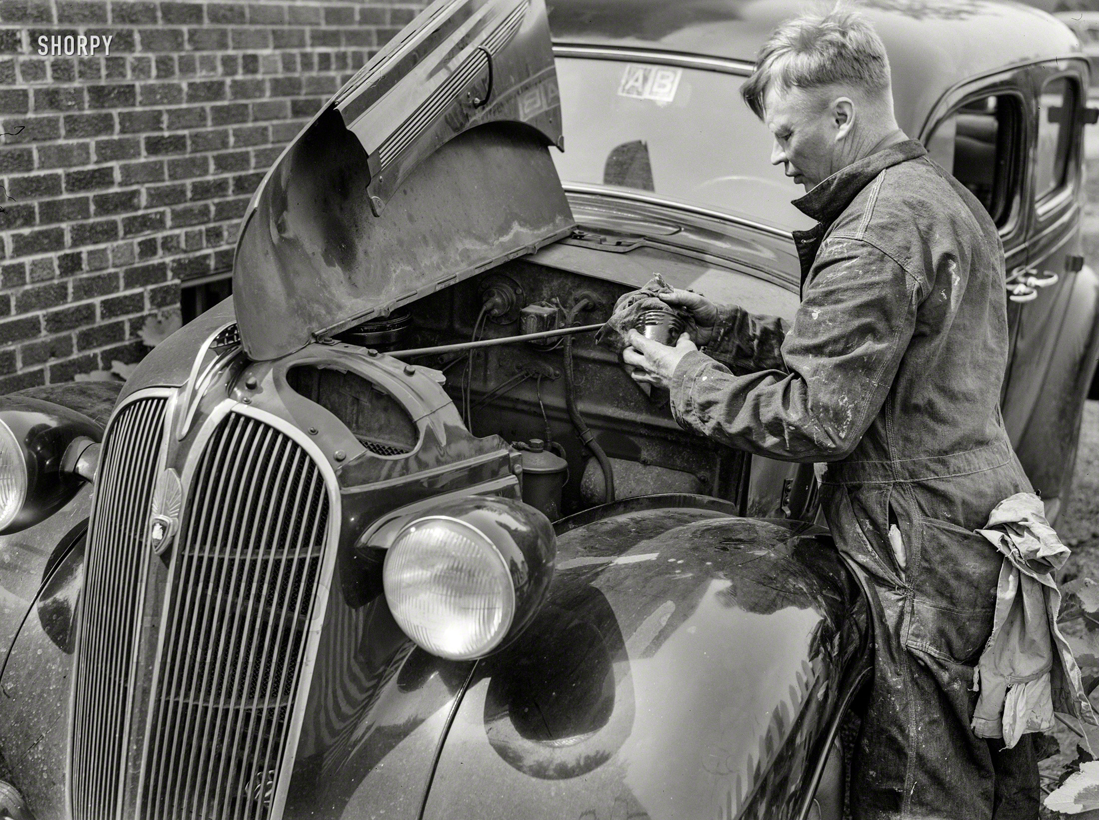 June 1943. Silver Spring, Md. "Man repairing his automobile." The Plymouth seen here. Photo by Ann Rosener, Office of War Information. View full size.