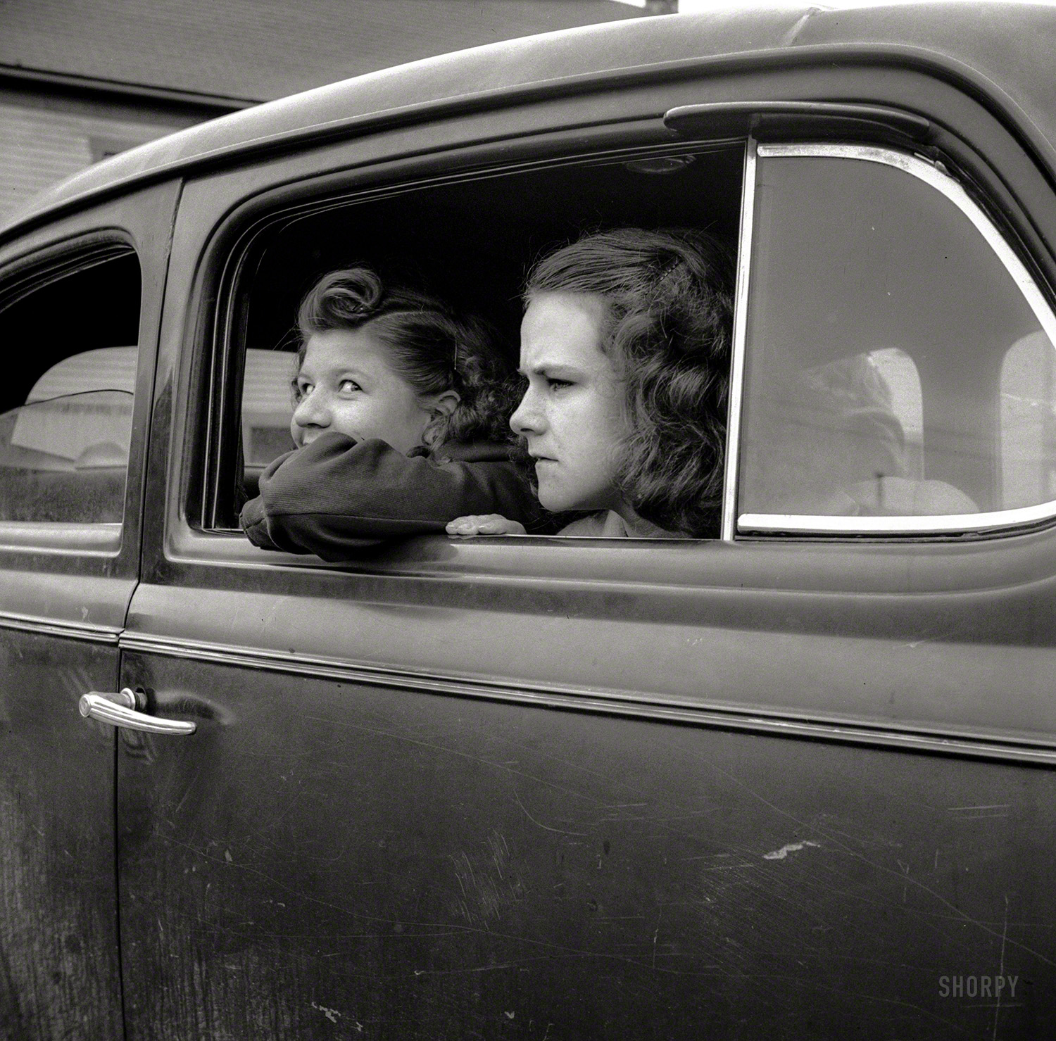 May 1943. Ashland, Aroostook County, Maine. "Girls at Memorial Day parade. Even with gasoline rationed, many people attended the ceremony in cars." Photo by John Collier for the Office of War Information. View full size.