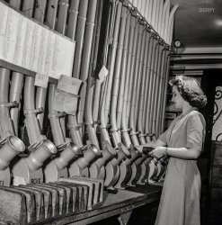 June 1943. Washington, D.C. "Miss Helen Ringwald, employee at the Western Union telegraph office, works with the pneumatic tubes through which messages are sent to branches in other parts of the city for delivery." Medium format nitrate negative by Esther Bubley for the Office of War Information. View full size.