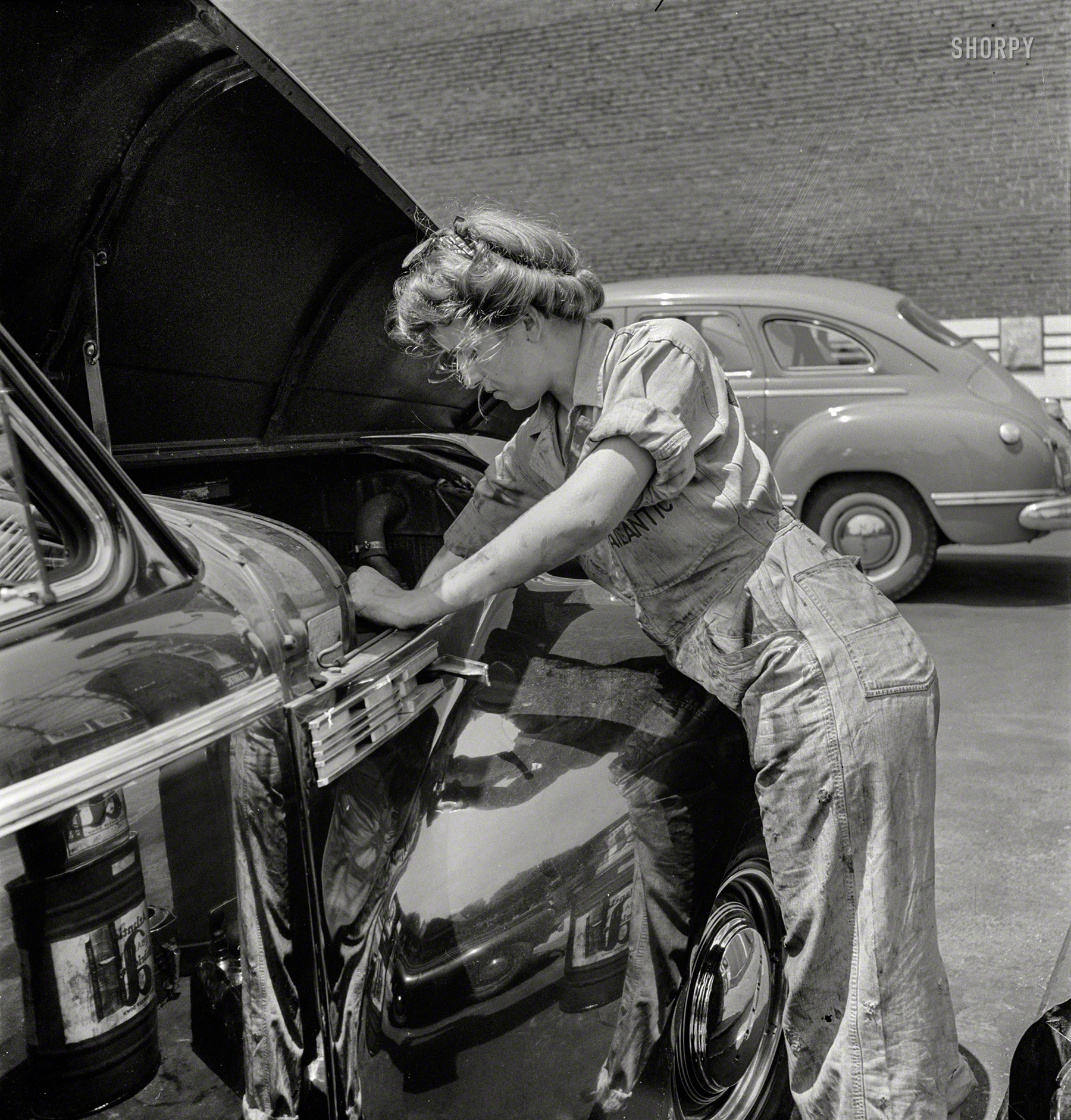 June 1943. "Philadelphia, Pennsylvania. Miss Natalie O'Donald, attendant at the Atlantic Refining Company garages." A Gibson Girl in coveralls. Medium format negative by Jack Delano for the Office of War Information. View full size.
