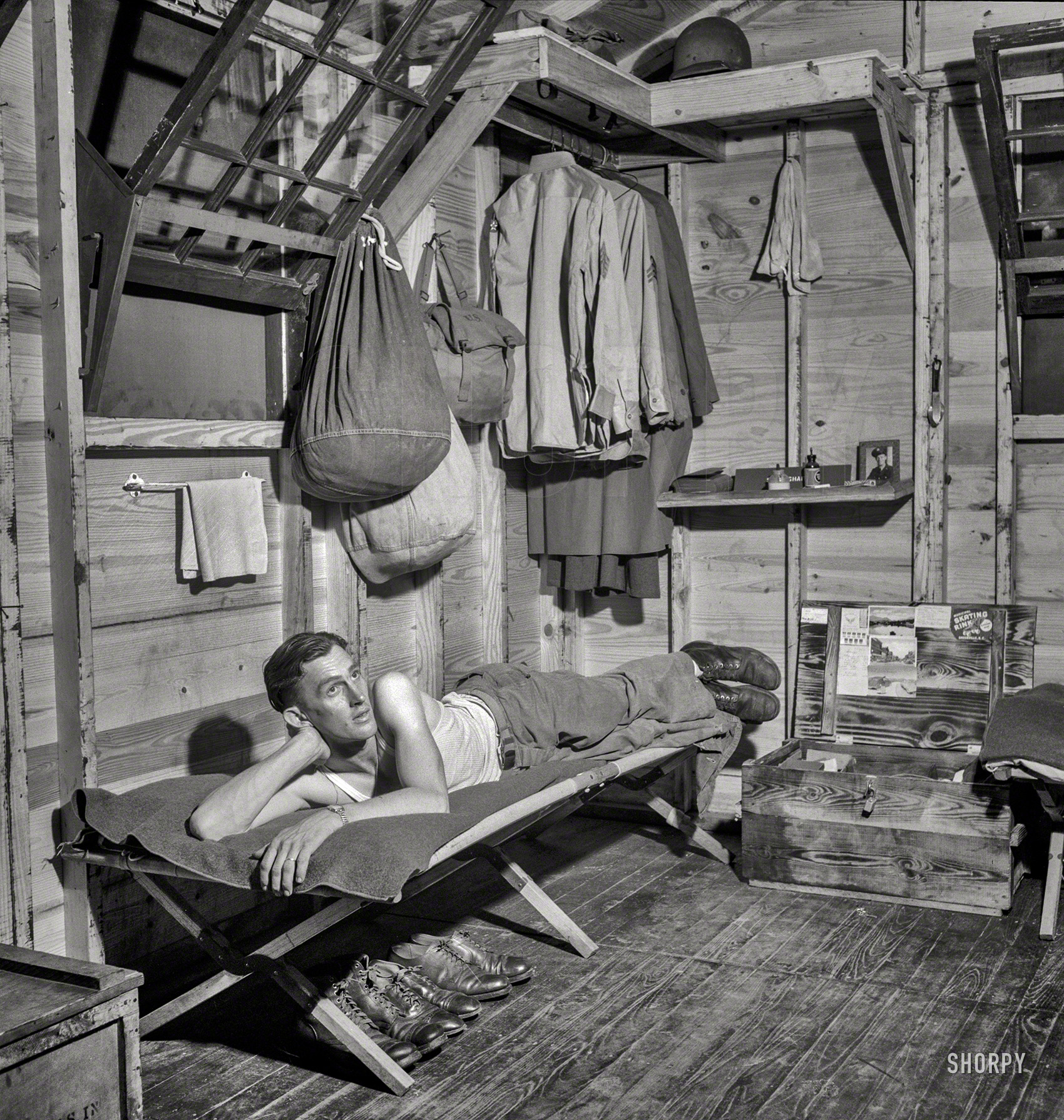 July 1943. Greenville, South Carolina. "Air Service Command. Enlisted man of the 25th Service Group relaxing in his hutment." Medium-format negative by Jack Delano for the Office of War Information. View full size.