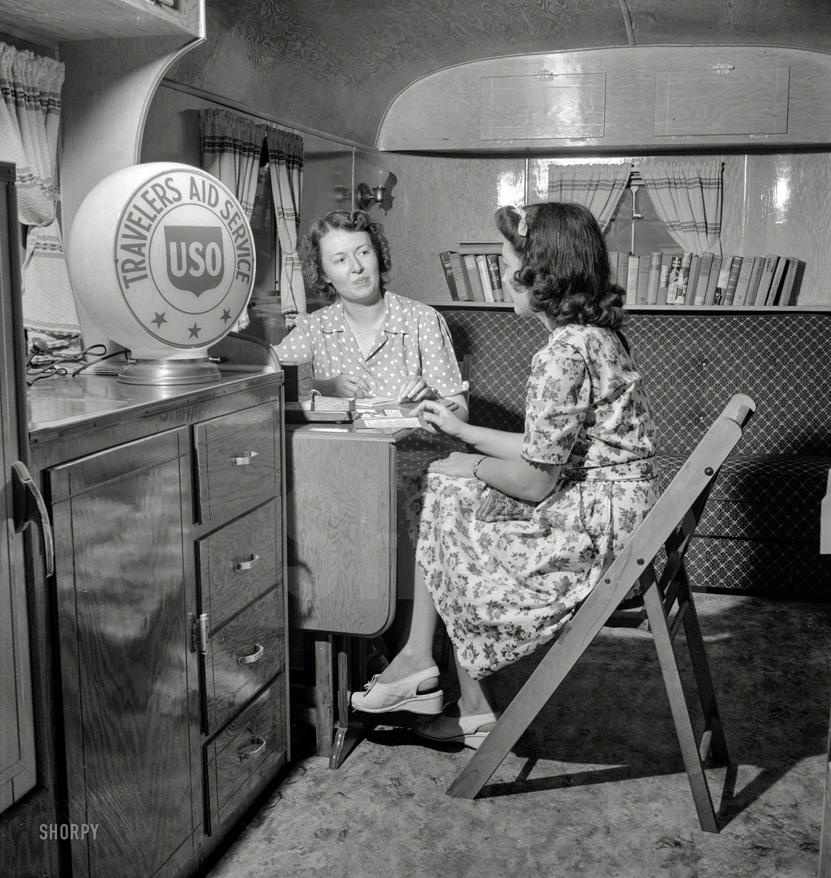 August 1943. "Middle River, a small crossroads in the vicinity of Baltimore, Maryland. Farm Security Administration housing project for Martin aircraft workers. Mrs. Helen Bird, USO traveler's aide, giving information to a newcomer in the Glenn L. Martin trailer village." Photo by John Collier. View full size.