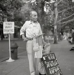 July 1943. Washington, D.C. "A man selling flags and buttons at the parade to recruit civilian defense volunteers." Medium format negative by Esther Bubley for the Office of War Information. View full size.
