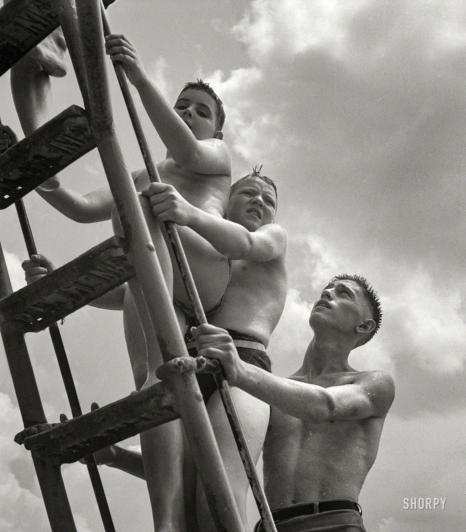 July 1943. Montgomery County, Maryland. "Climbing the ladder to the sliding board at the Glen Echo swimming pool." Medium format nitrate negative by Esther Bubley for the Office of War Information. View full size.
