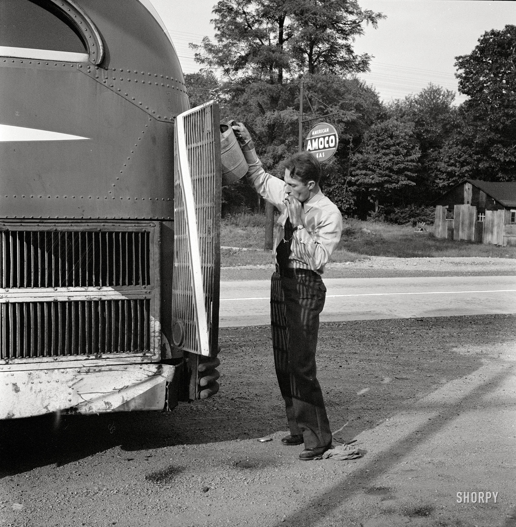 September 1943. "A Greyhound bus that has been stopped at a filling station to get water between Washington, D.C., and Pittsburgh." Medium format nitrate negative by Esther Bubley for the Office of War Information. View full size.