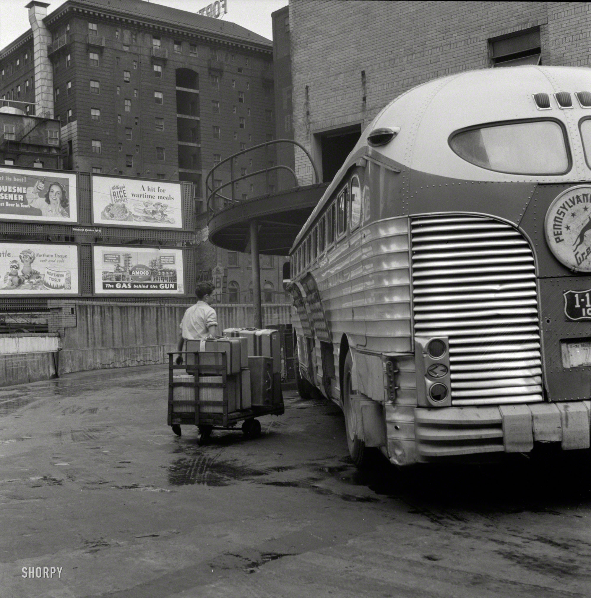 September 1943. "Pittsburgh, Pennsylvania. Bringing baggage from a bus." Photo by Esther Bubley for the Office of War Information. View full size.