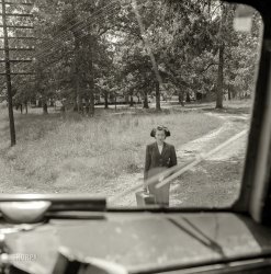 September 1943. "Greyhound bus trip from Louisville, Kentucky, to Memphis, Tennessee, and the terminals. Girl waiting for bus by road's edge." Medium format negative by Esther Bubley for the Office of War Information. View full size.