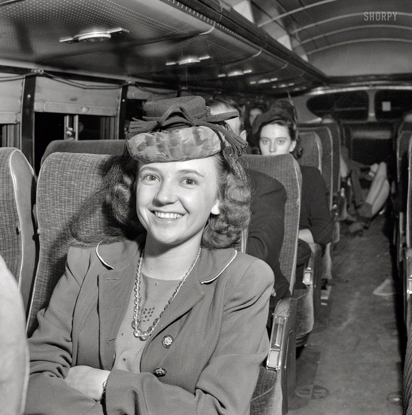 September 1943. "A Greyhound bus trip from Louisville to Memphis and the terminals. Roberta Locker, going to Chattanooga from Elora, Tenn., to work." Co-starring Roberta's hat, an elaborate construction of netting, fabric and feathers. Photo by Esther Bubley for the Office of War Information. View full size.