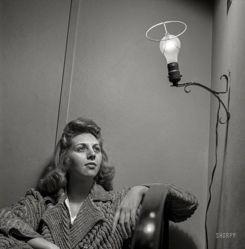 January 1943. Washington, D.C. "This Office of Price Administration clerk, speaking of her boardinghouse room, says: 'The light looks like an angel when I leave the shade off, so I do so'." Photo by Esther Bubley. View full size.
