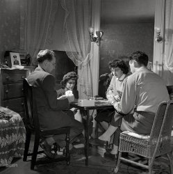 January 1943. "Washington, D.C. After dinner a bridge game goes on nightly in the largest room in the boardinghouse." Medium format nitrate negative by Esther Bubley for the Office of War Information. View full size.