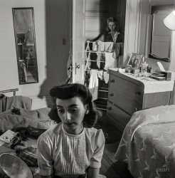 January 1943. Washington, D.C. "Girl in the doorway of her room at a boarding&shy;house." With photographer Esther Bubley (or sister Enid) front and center. Medium format negative for the Office of War Information. View full size.