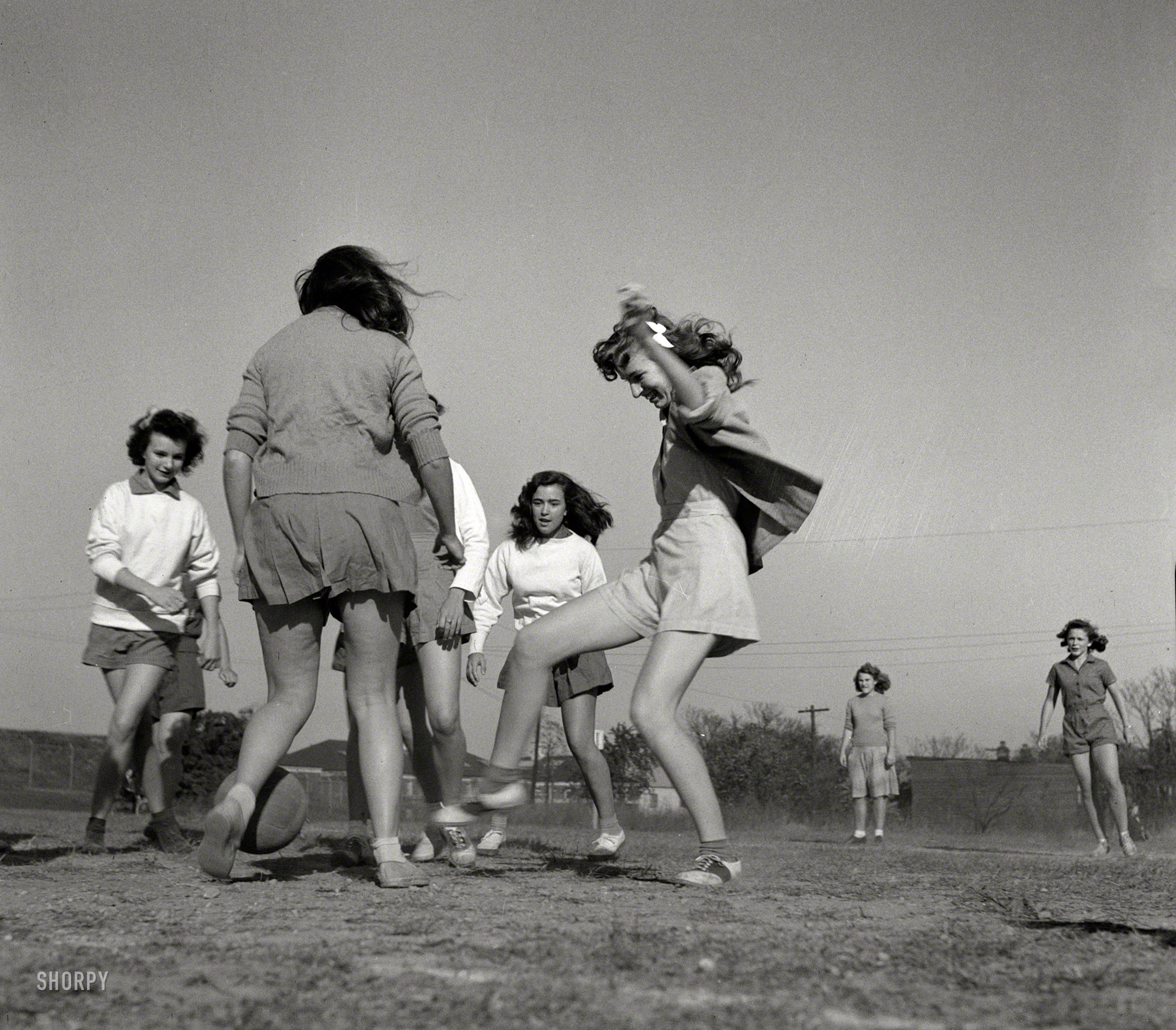 October 1943. Washington, D.C. "Girls playing soccer in physical education class at Woodrow Wilson High School." Saddle Shoes connects in a 1-0 nail-biter. Photo by Esther Bubley for the Office of War Information. View full size.