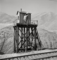 November 1942. "Bingham Canyon, Utah. Signalman of the Utah Copper Company at its open-pit mine workings." Photo by Andreas Feininger, Office of War Information. View full size.
