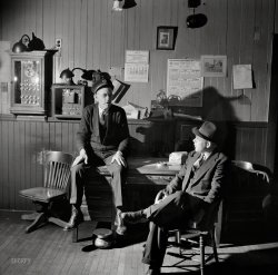 May 1942. Southington, Conn. "Thomas J. Murphy, chief of the fire department, and its only salaried member, chatting with one of the volunteers." Medium format negative by Fenno Jacobs for the Office of War Information. View full size.